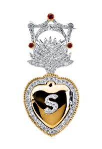 platinum and 18kt yellow gold flaming heart locket accented with round brilliant diamonds and filigree with S initials and rubies