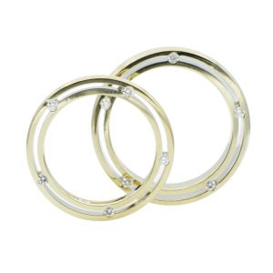 platinum and diamond matching his and her wedding bands with tension setting