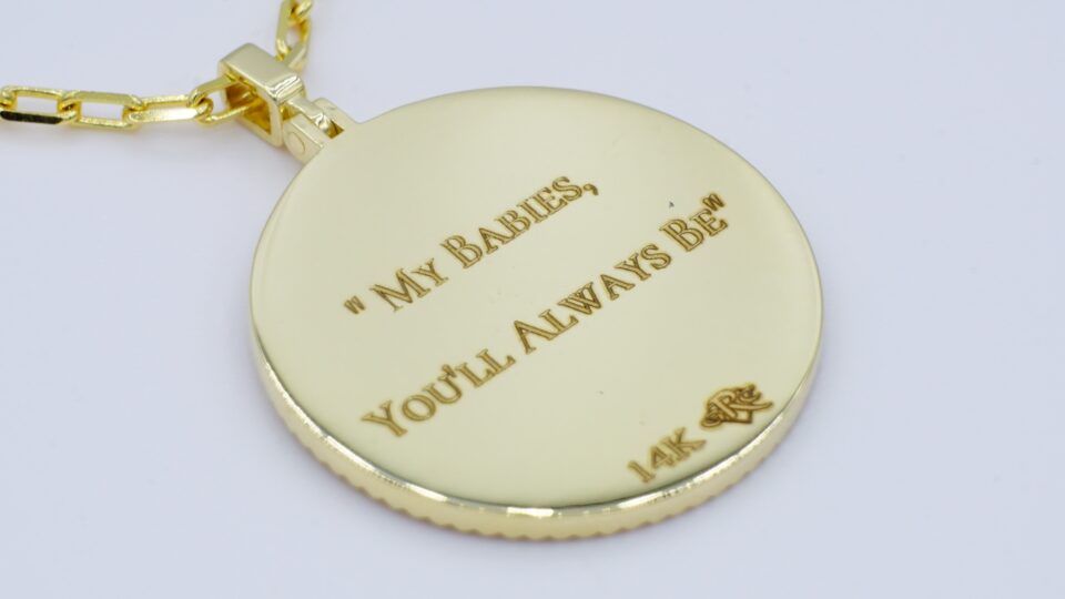 back side of a gold mother's medallion pendant